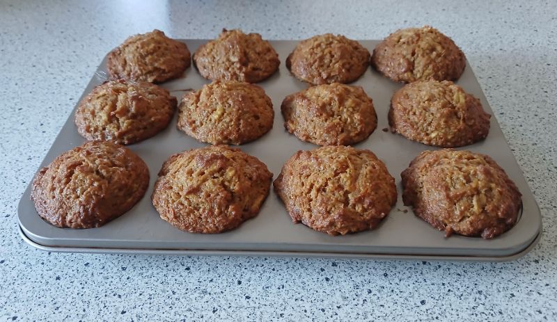 Freshly baked muffins cooling in the tin